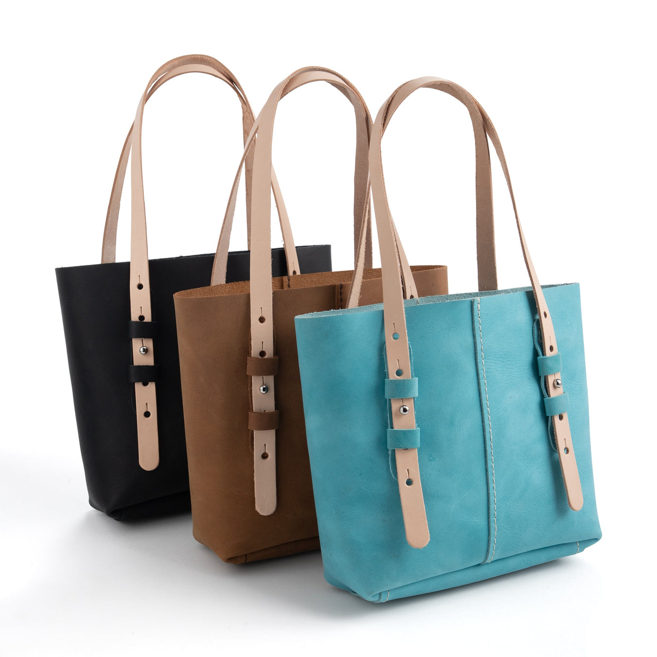 Three satchel bags in black, brown, and blue colors with adjustable straps and nickel plate button studs.