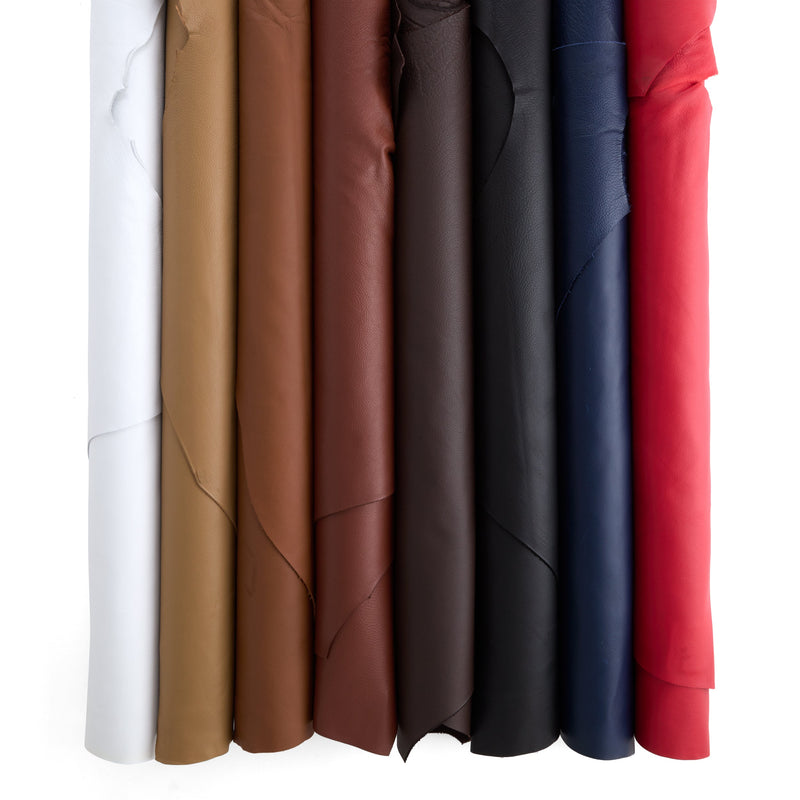 Set of chrome tan leather sides in various colors on a white background